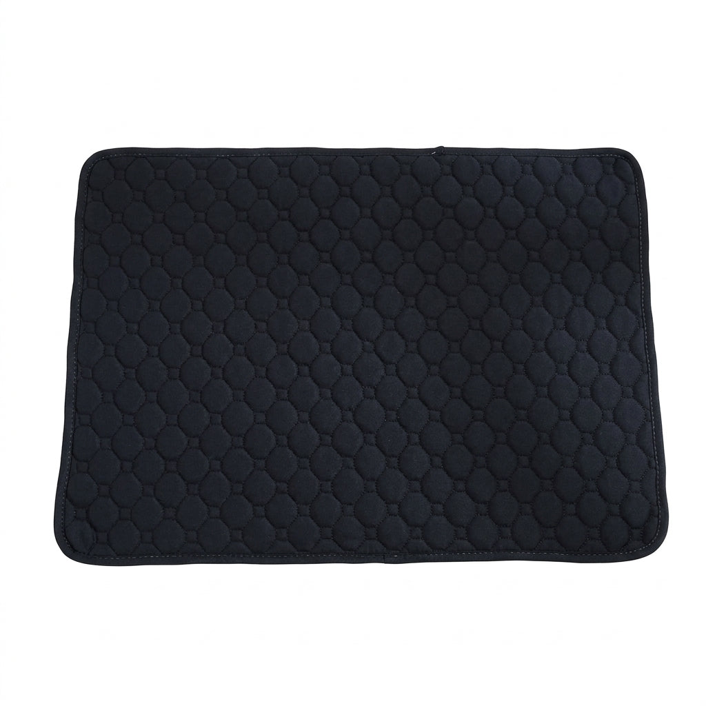 Black quilted pet mat with an octagon stitch pattern and rounded corners, seen from above