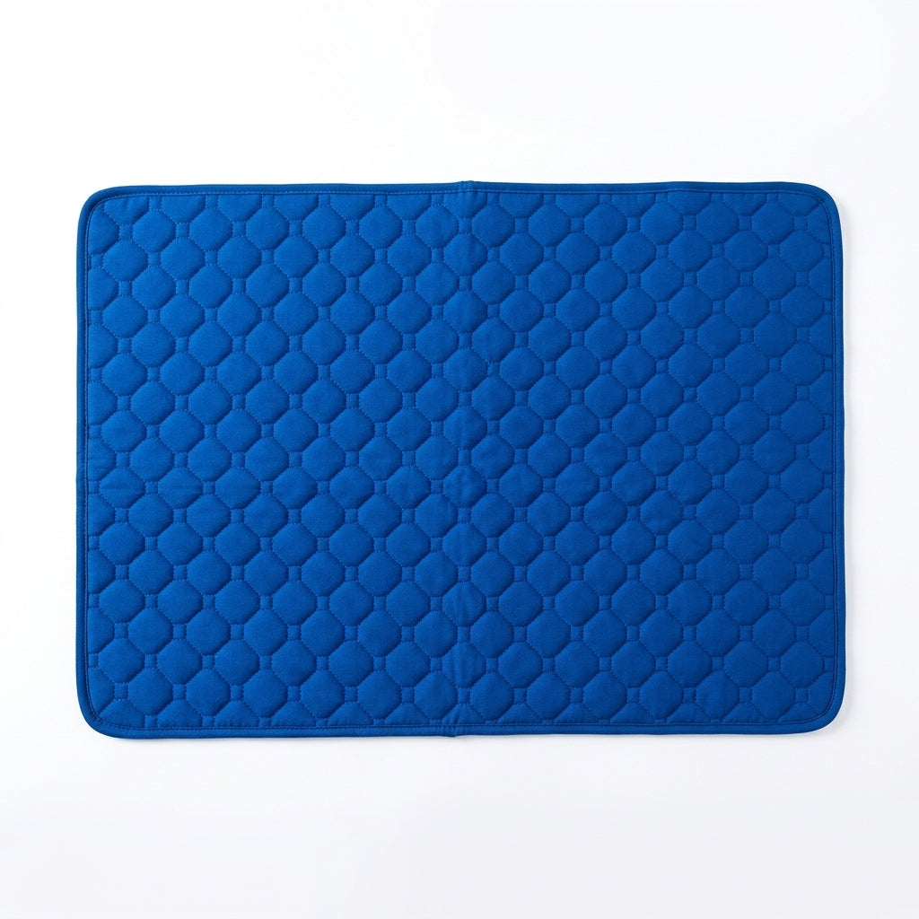 Royal blue quilted pet mat with octagon stitching and a matching bound edge, seen from above