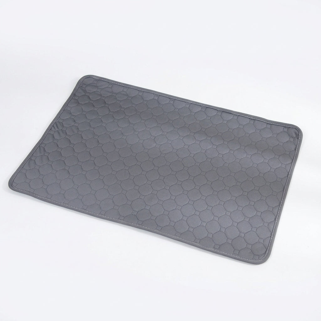 Grey quilted pet mat with an octagon stitch pattern, lying flat at an angle on a white surface