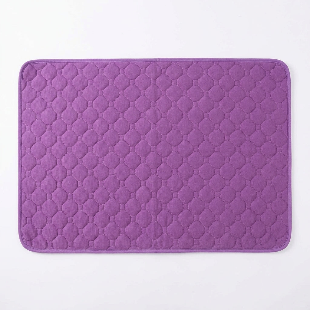 Purple quilted pet mat with octagon stitching and a purple bound edge, seen from above