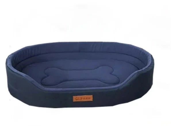 Oval dog bed in navy Oxford fabric with high padded sides and a bone shape stitched on the cushion
