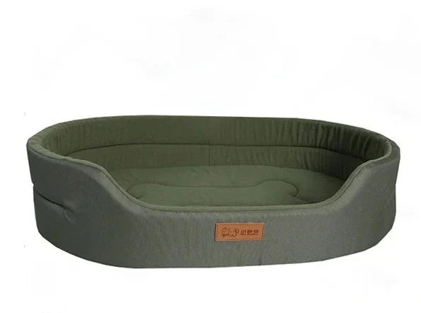 Oval dog bed in olive green Oxford fabric with high padded sides and a low front entry