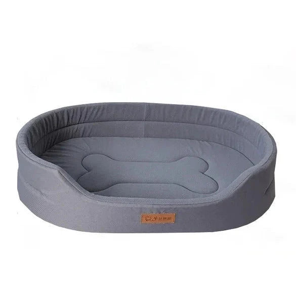 Water resistant dog bed in grey Oxford fabric, oval with high padded sides and a bone shape stitched on the cushion