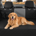 Golden retriever lying on a black quilted waterproof dog hammock fitted across the back seat of a car